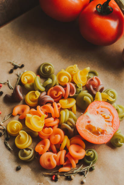 istock ingredients for pasta. process of cooking pasta. natural dyes for pasta (tomato, spinach, carrots) 949884966