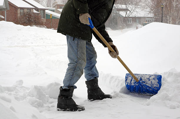 Man shoveling snow. Winter morning - Canada