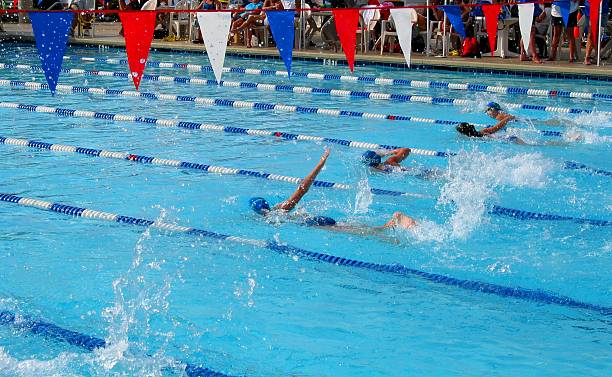 Swimmers racing in their lanes at a competitive meet