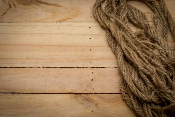 Aged rope on the old wooden pattern background