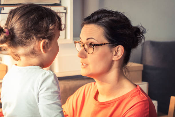 Mother talking to her daughter. Middle aged mother enjoying in conversation with her small girl. explaining stock pictures, royalty-free photos & images