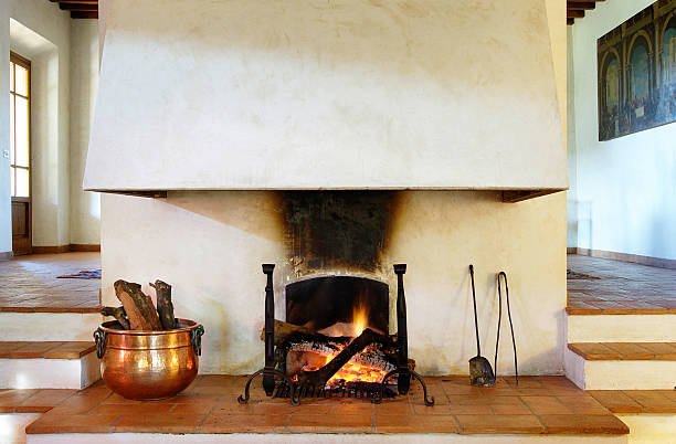 istock Fireplace in rustic house, terracotta floor, copper recipient for logs 94993218