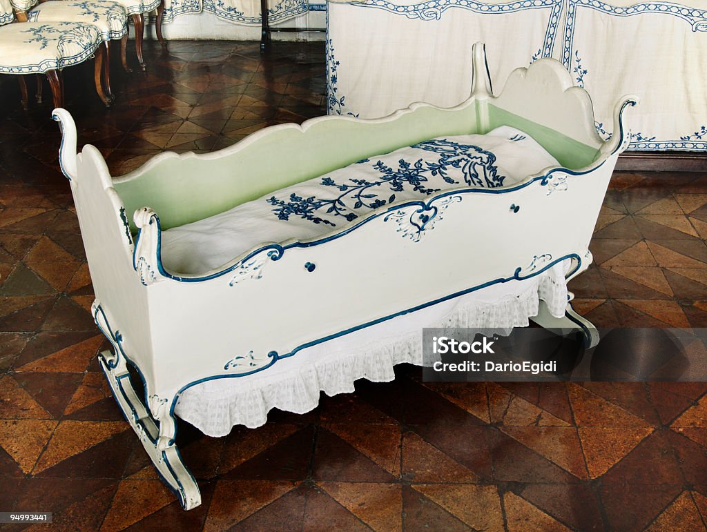 Old vintage cradle, white and blue, Guarene Castel, baroque architecture  Crib Stock Photo