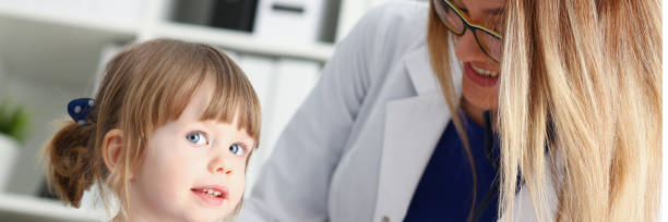 istock Little child with stethoscope at doctor reception 949940842