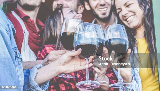 Happy Friends Cheering With Red Wine At Barbecue Dinner Young People Having Fun And Laughing Together In Vineyard Farm Focus On Close Up Glasses Friendship Party And Youth Concept Stock Photo - Download Image Now