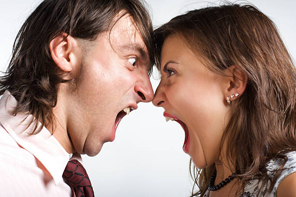 istock Man and woman looking into each other's eyes screaming 94995833