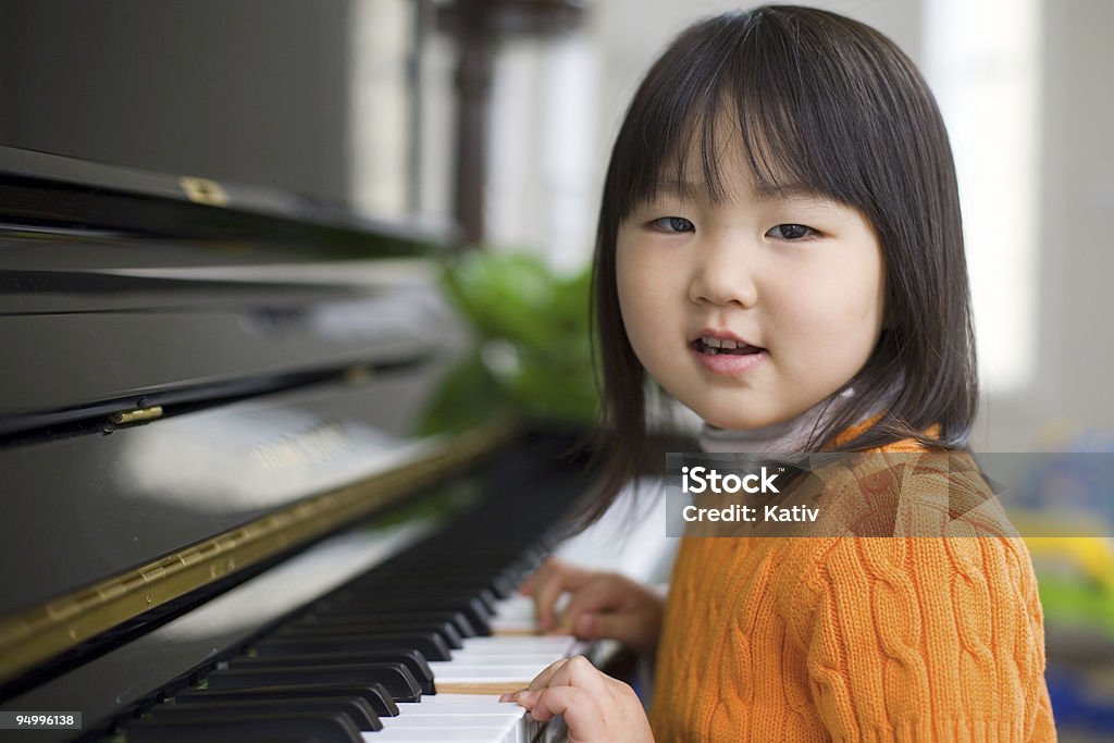 Ragazza asiatica Piano di apprendimento - Foto stock royalty-free di Pianoforte