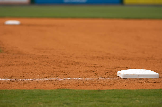 Baseball Field at Major League Baseball Game A DSLR of a Baseball field at a baseball game. the photo is a close up of third base and second base in the infield at a professional baseball game or major league baseball game or little league baseball. Each base is white and the grass is green and the dirt is orange. the lighting is natural sunlight during the day with baseball stadium lighting. there are no baseball players in the photo. the photo is an abstract sports background picture. 

more baseball pictures:
click here
[url=http://www.istockphoto.com/file_search.php?action=file&lightboxID=4651500][img]http://www.istockphoto.com/file_thumbview_approve.php?size=1&id=5073108[/img][/url]

 baseline stock pictures, royalty-free photos & images