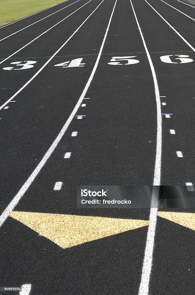 Track Lanes at Track and Field Running Event this picture is of Track Lanes at a Track and Field Running Event. lane one and lane two are in the picture. and the picture is a close up of lane one at a track and field event. the picture was taken at a sporting event. the lighting is natural sunlight. and the picture was taken during the day.  Abstract Stock Photo