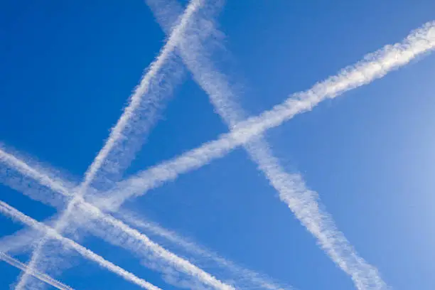 Airplane vapor paths crossing across the sky.