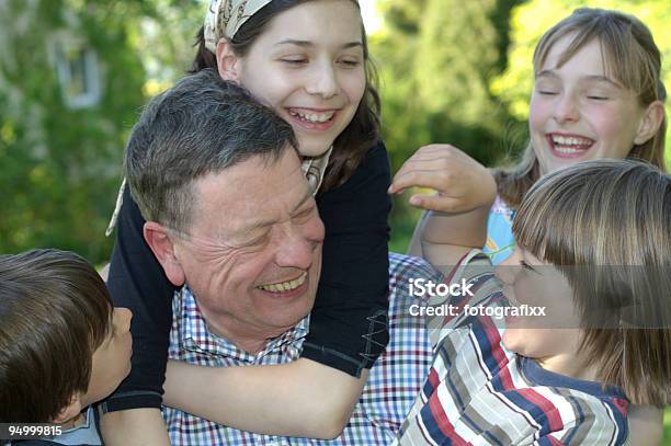 Divertimento Estivo Gruppo Di Bambini Che Abbraccia Ridere Nonno - Fotografie stock e altre immagini di 60-69 anni