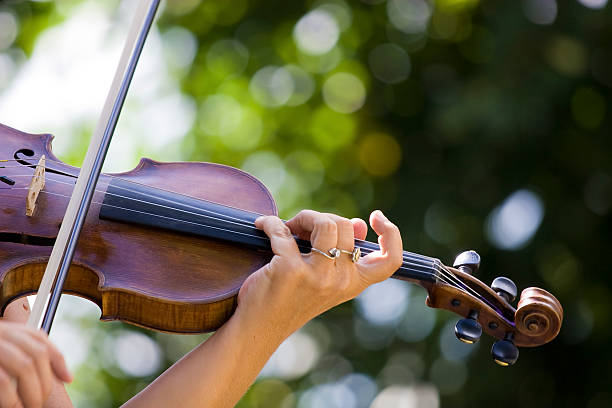istock Female violinist playing outdoors on a sunny day 95000424