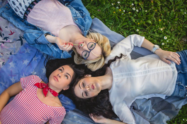 istock Cute friends lying in park 950008644