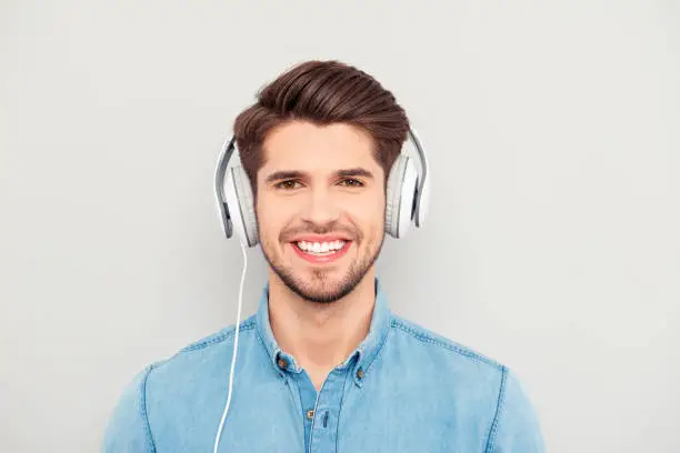 Photo of Cheerful relaxed music lover listening music in headphones