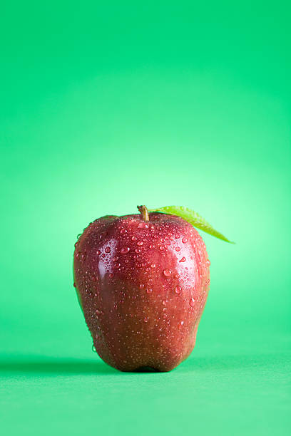 Red Apple on green background stock photo