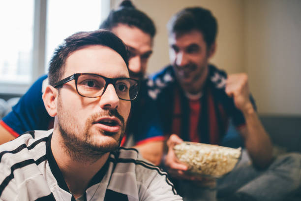 istock Soccer fan watching a game with friends 950020430