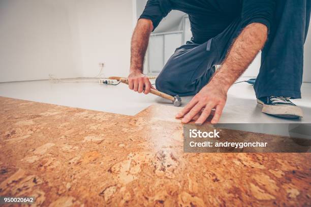 Master Picks A Series Of Cork Floor Cork Flooring With A Hammer Stock Photo - Download Image Now