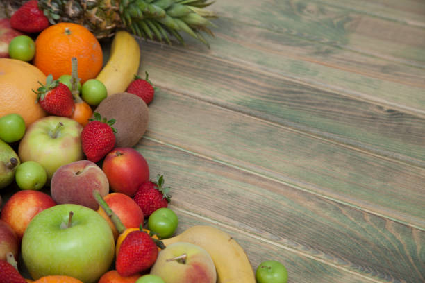 istock Fruits on wooden background. 950021090