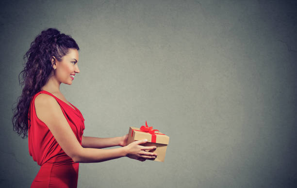 istock woman giving a great present 950028188