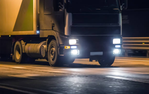 istock truck moves on highway at night 950032270