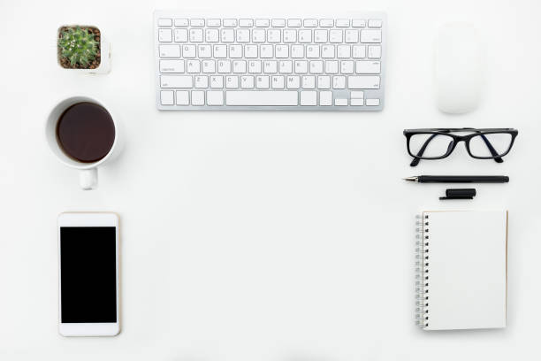 istock Modern white office table with computer gadgets and supplies. Top view with copy space, flat lay. 950035662