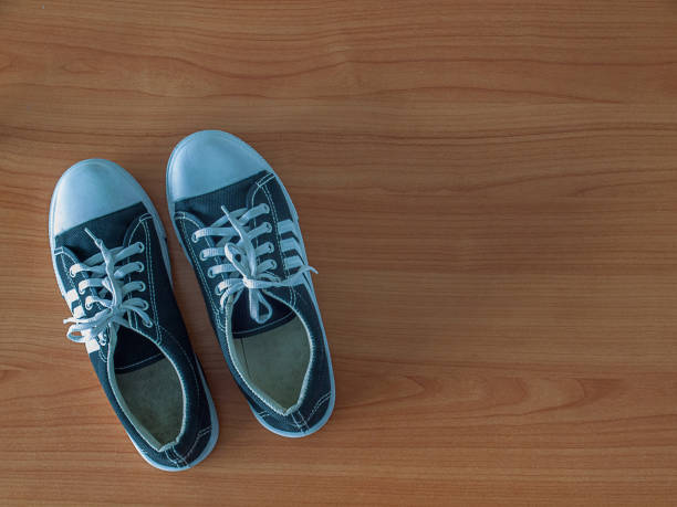 istock old sneaker isolated on wooden floor. 950044308