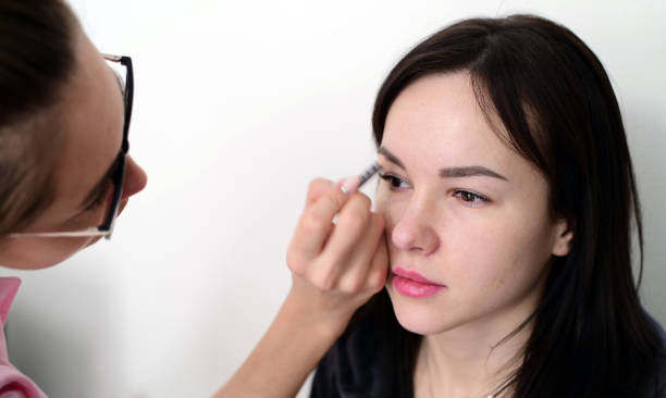 istock makeup artist paints eyebrows young dark-haired girls 950047088