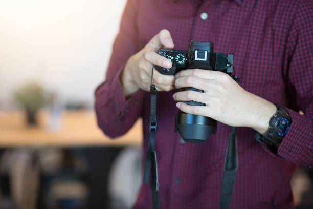 istock Man holding camera Wearing a red and black plaid. 950057530