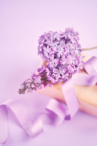 Arrangement for Mother's day with lilac flowers and a wrapped gift