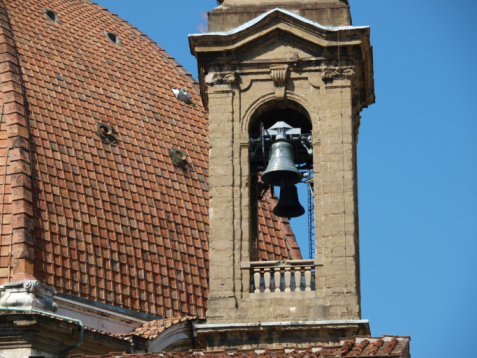 A view of bells on tower of white church building