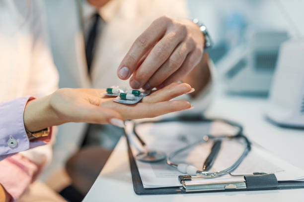 istock Photo of Scientists examining pills in lab 950086754