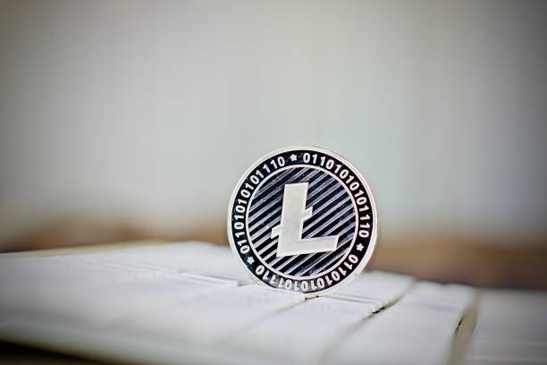 Litecoin coin Digital currency physical metal silver Litecoin coin on the white computer keyboard. litecoin stock pictures, royalty-free photos & images