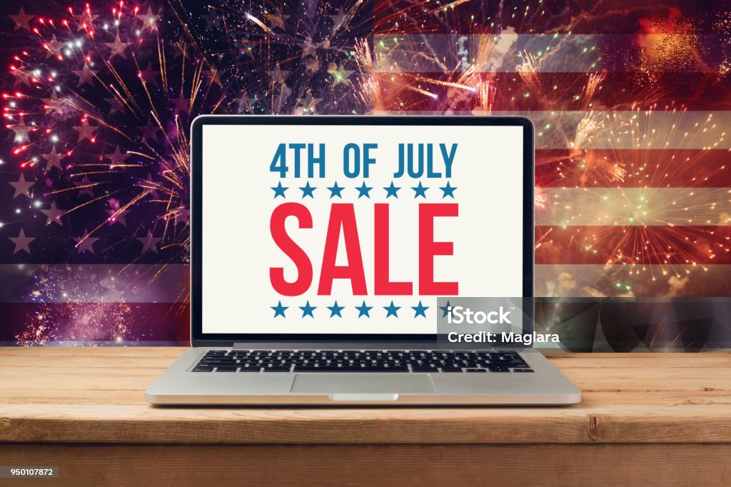 4th of july sale concept 4th of july sale concept with laptop computer mock up over fireworks background Fourth of July Stock Photo