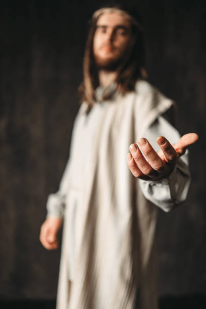 istock Jesus Christ in white robe reaching out his hand 950111142