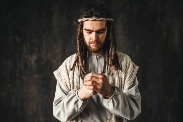 istock Man in the image of Jesus Christ praying 950111228