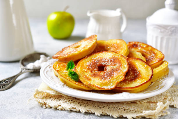 Apple pancakes for a breakfast Apple pancakes for a breakfast on white plate over light slate, stone or concrete background. fritter photos stock pictures, royalty-free photos & images