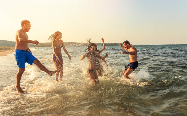 istock Friends having fun in the sea 950112118
