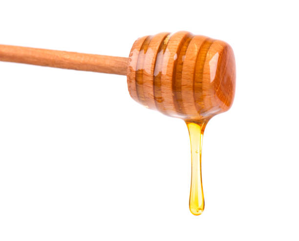 istock Honey dripping isolated on white background. Honey isolated 950112296