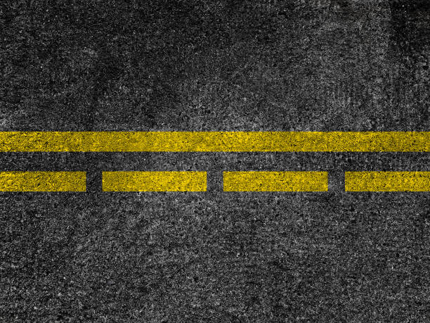 istock Asphalt road with dividing yellow lines. 950119502