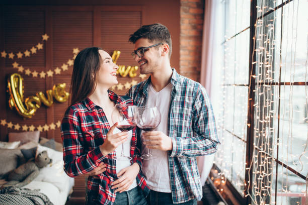 istock Young couple hugs against large window from floor 950122966