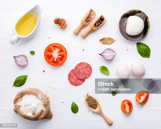 The Ingredients For Homemade Pizza With Ingredients Sweet Basil Tomato Garlic Bay Leaves Pepper Onion And Mozzarella Cheese On White Wooden Background With Flat Lay Stock Photo - Download Image Now