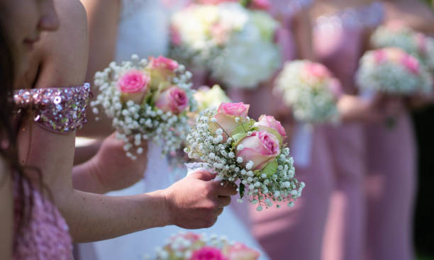 istock A bride and bridesmaids in pink dresses holding their bouquets. 950144416