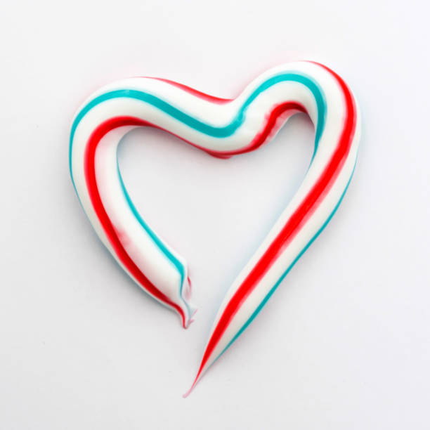 istock heart symbol is made of three-color toothpaste on white background, concept abstract background 950144722