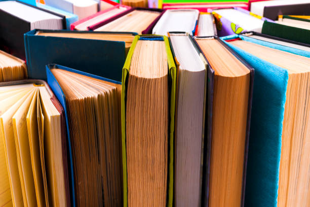istock Open book, hardback books on bright colorful background. 950144916