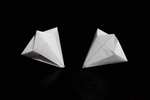 istock Origami folding paper, paper diamonds in a black background composition 950148164