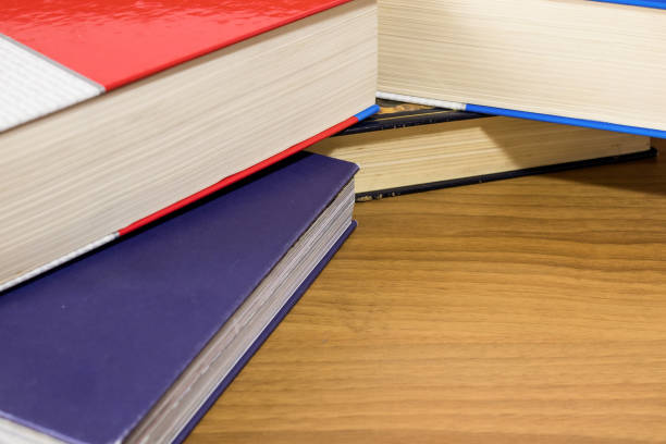 istock School, a pile of red and blue books on a wood table composition 950148228