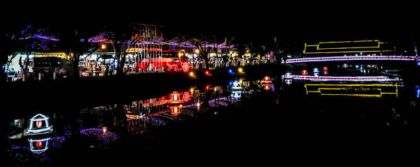 Illuminated bridge and night market in Siem Reap, Cambodia. stock photo