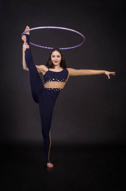 istock Gymnastic exercises with hula Hoop girl performs a circus artist. 950148758