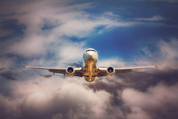 Passenger jet airplane flying above clouds Passenger jet airplane flying above clouds boeing 737 photos stock pictures, royalty-free photos & images