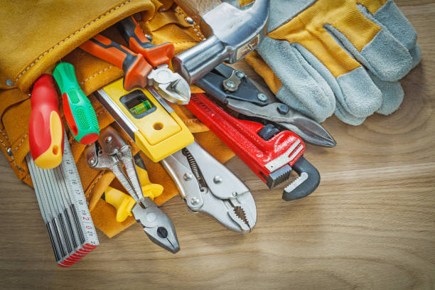istock Tools in leather building belt on wooden board top view 950156992
